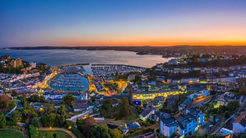 Torbay coastline at sunset with beach and cliffs